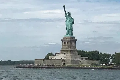 NYC Bus & Boat Adventure: Liberty, Landmarks & Local Lore!
