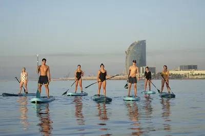Glide into Bliss: Paddle Surfing Barceloneta's Sparkling Coast