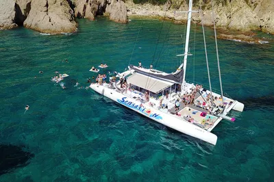 Costa Brava Catamaran Adventure: Sail, Barbecue & Beach Fun!